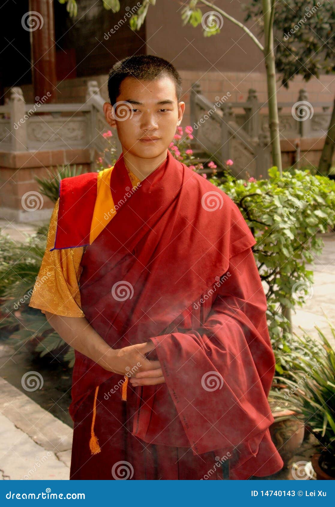 Young Monk Serving Tea To Other Monk In A Tibetan Buddhist Ceremony At
