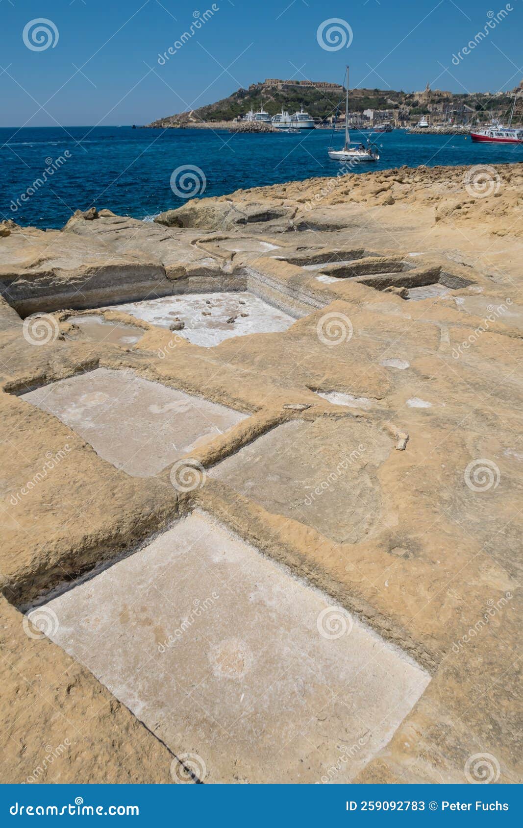 chequerboard of rock-cut saltpans on the shoreline in malta, gozo