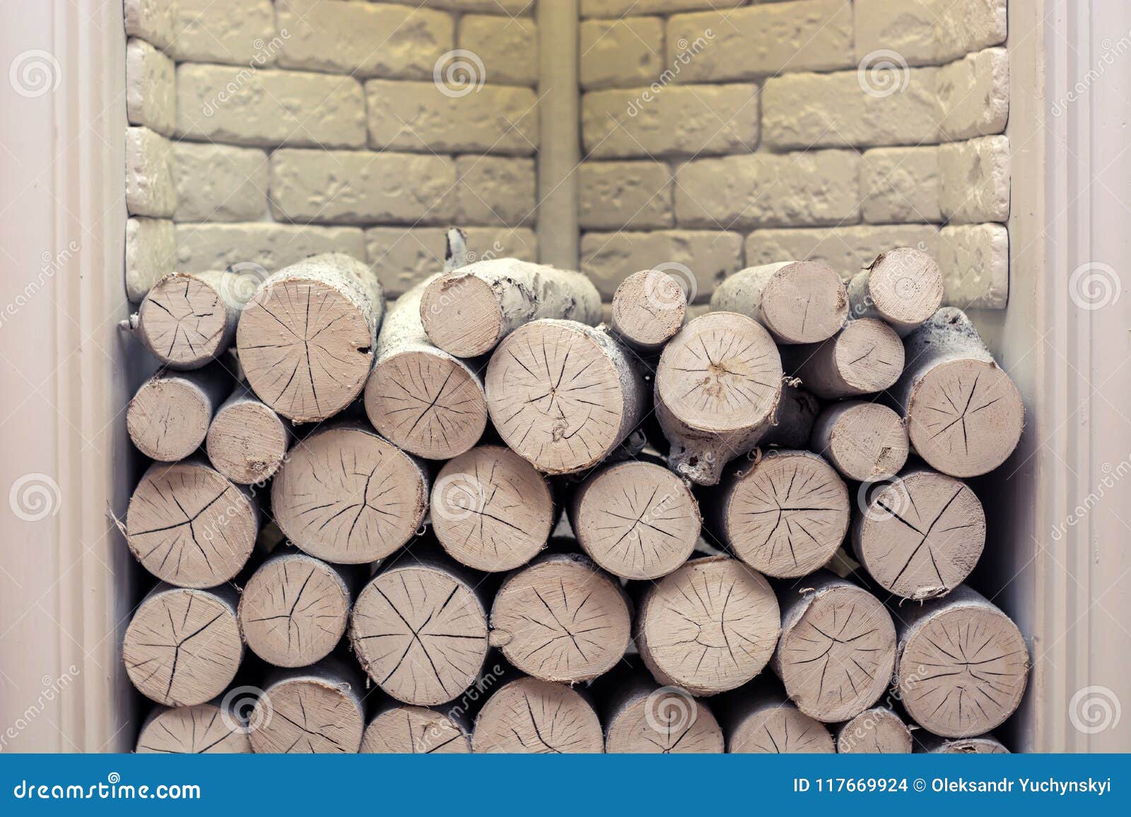 Cherry Firewood Stacked in a Decorative Fireplace Decorated with Bricks