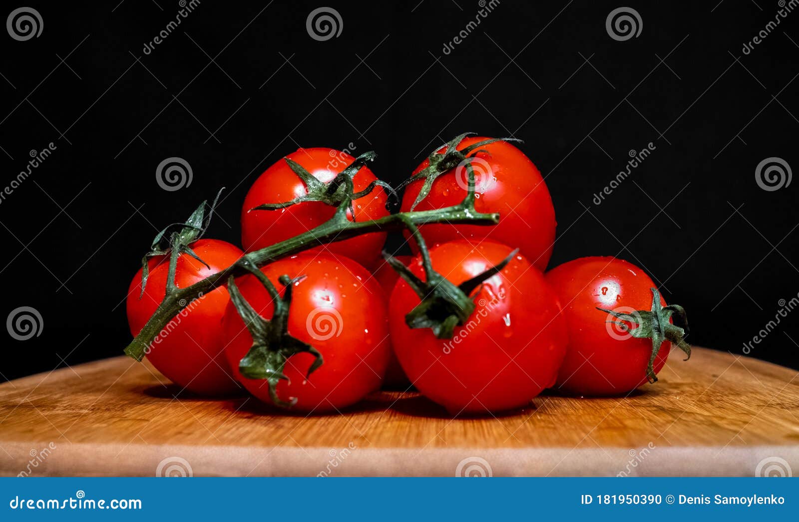 photo Tomato Chopping Board Background Free cherry tomatoes lie on a chopping board on black background stock photo 181950390 megapixl