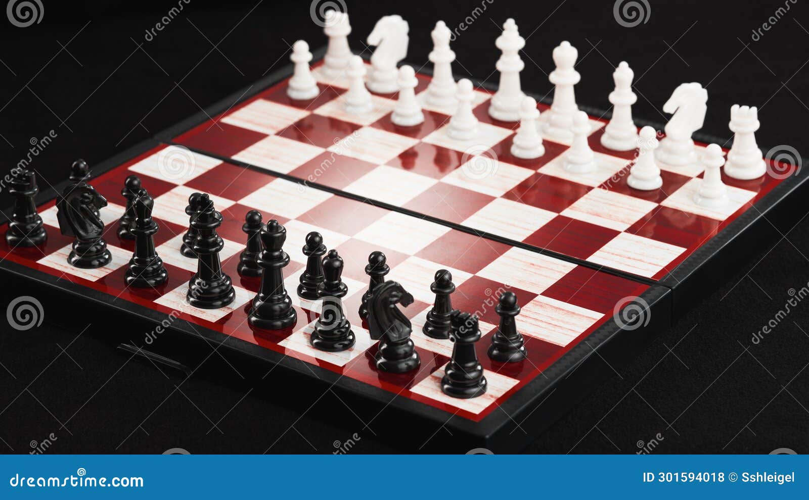 A Chessboard with Black and White Pieces Arranged at the Beginning of