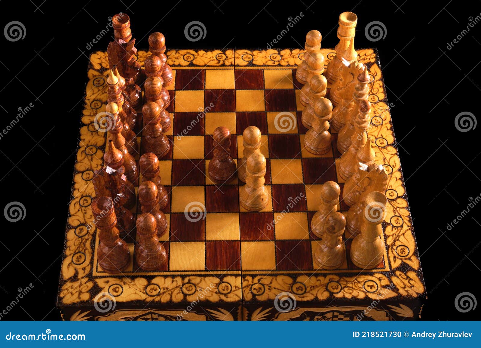 Vintage wooden chess set with queen gambit opening, close-up view