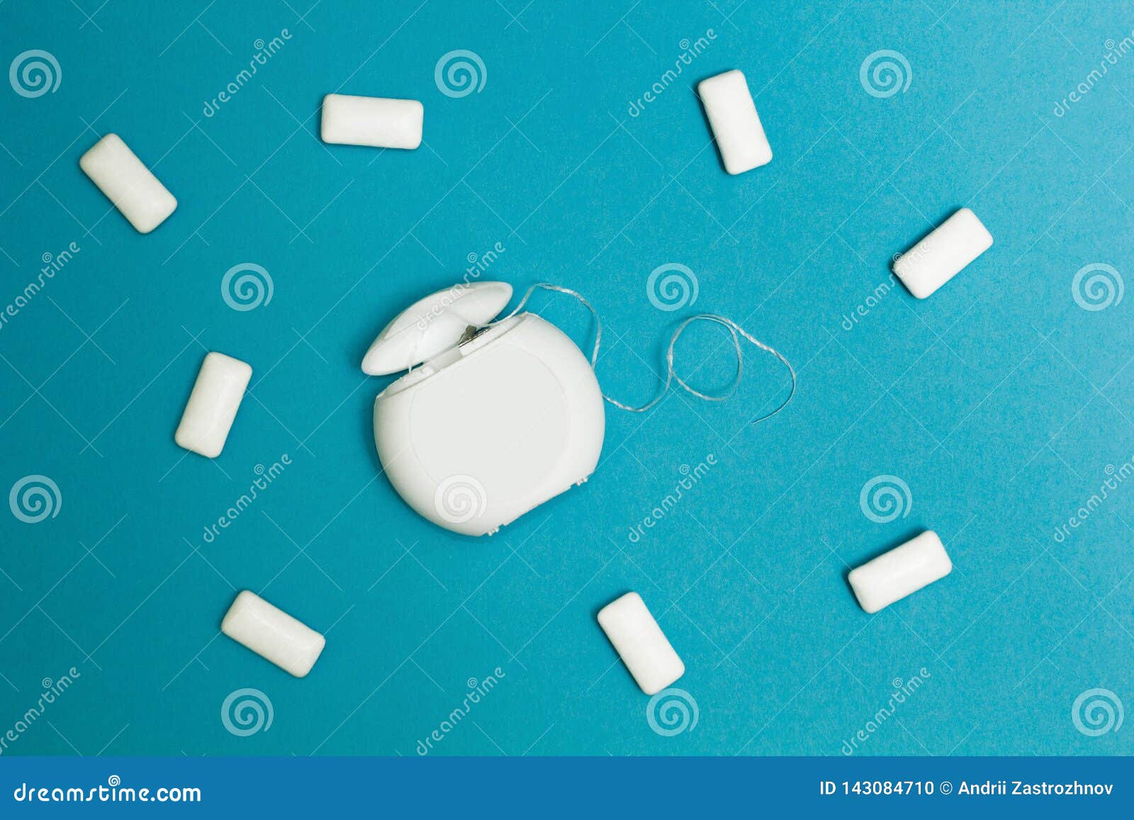 Chewing Gum and Dental Floss on a Blue Background Stock Photo Image