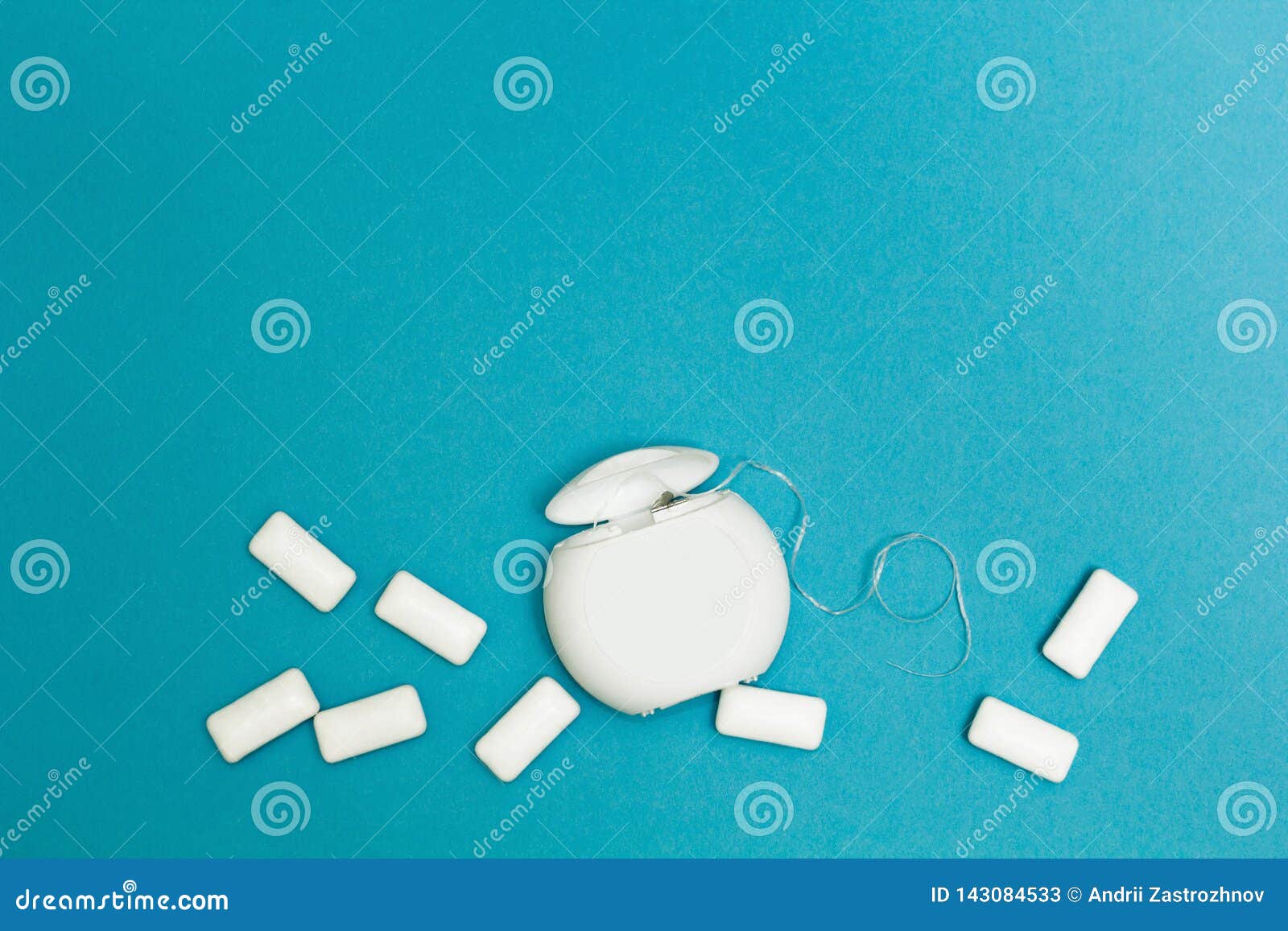 Chewing Gum and Dental Floss on a Blue Background. Space for Text Stock