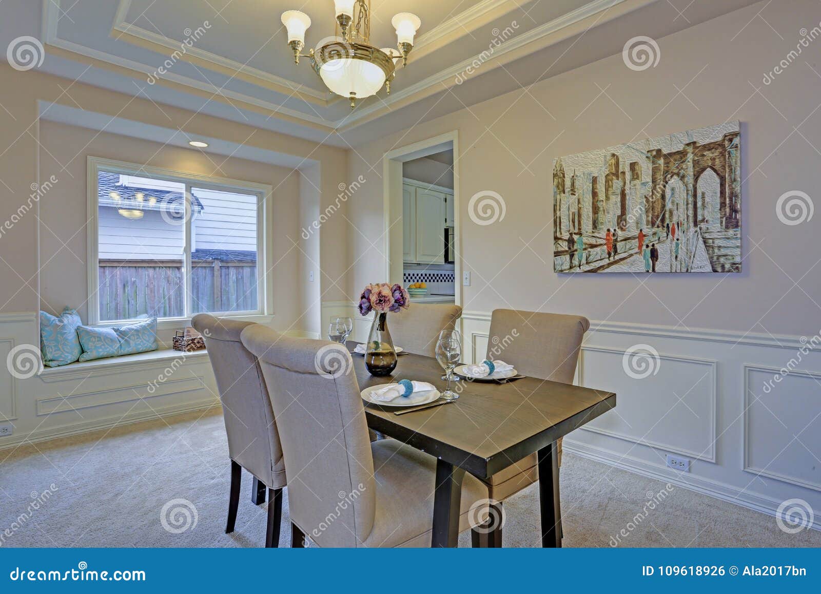 Chic Dining Room Accented With Wall Panel Mouldings And Tray