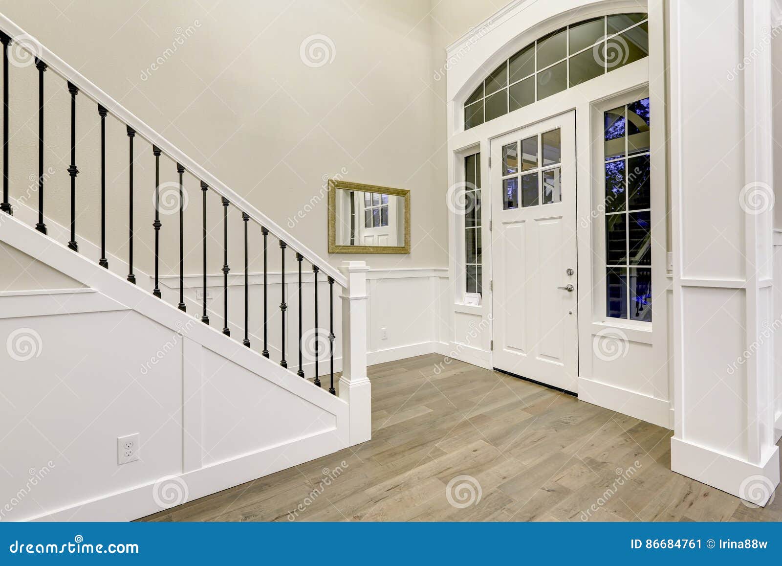 Chic White Entryway Design Accented With High Ceiling Stock Image