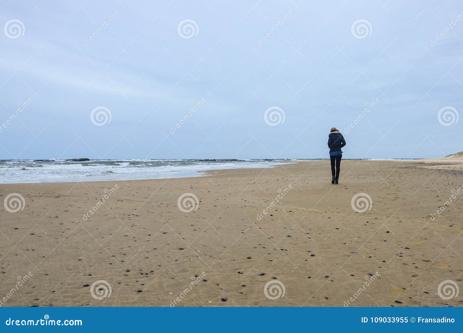 girl walking alone at the beach.