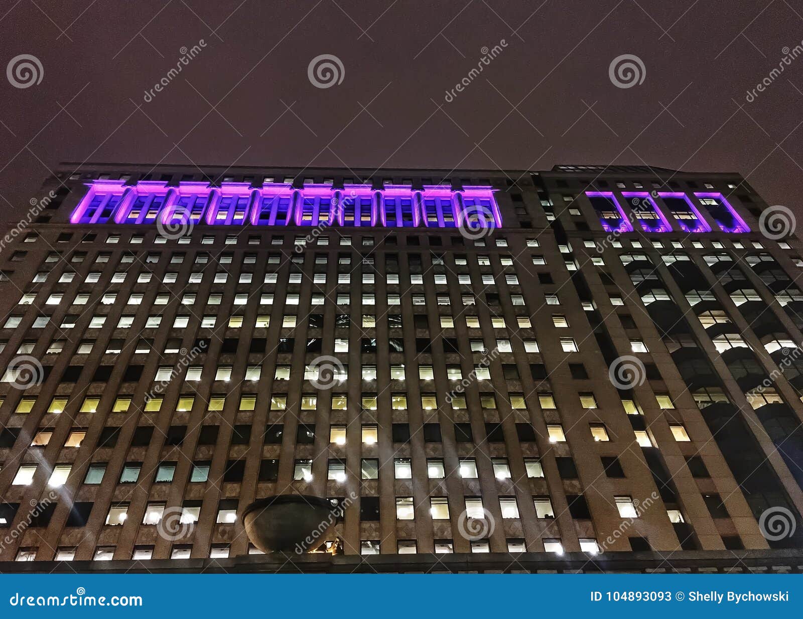 chicago`s illuminated cityscape as seen from riverwalk.