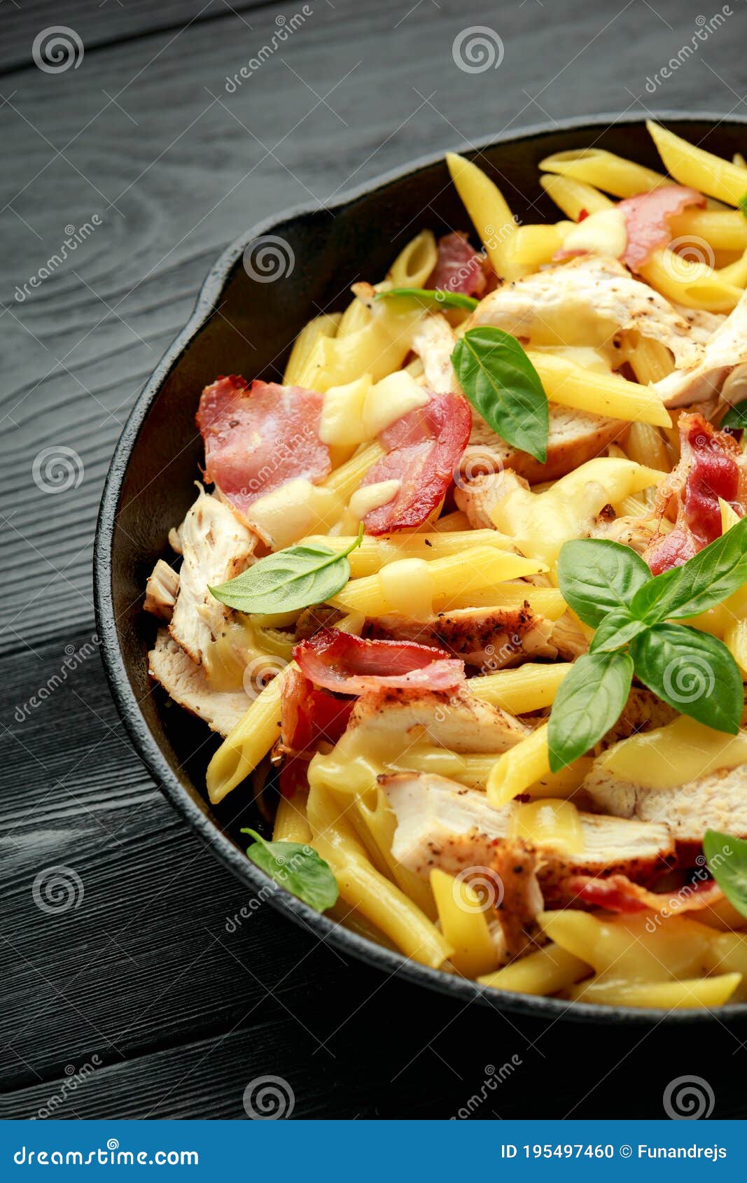 Chicken, Bacon Penne Pasta with Cheese and Basil in Iron Cast. Healthy