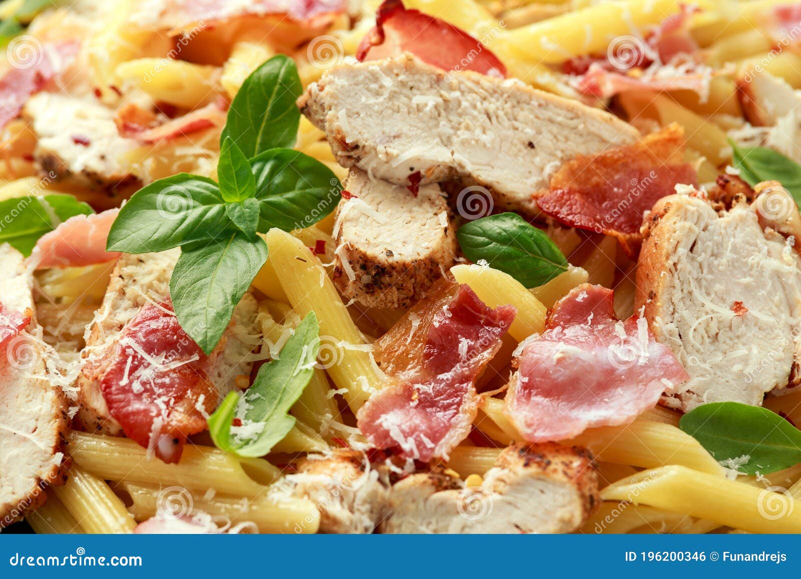 Chicken, Bacon Penne Pasta with Parmesan Cheese and Basil. Healthy Food