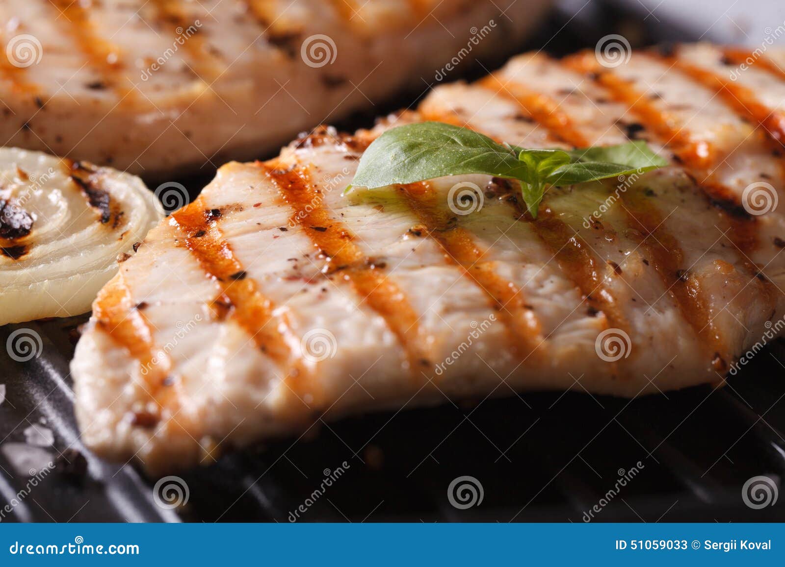 Chicken Breast with Onions and Basil on the Grill Macro Stock Image