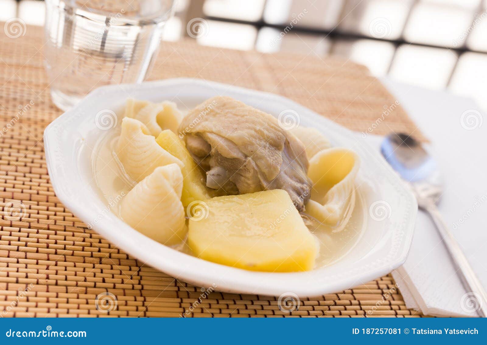 Chicken Broth Soup with Chicken, Potatoes, and Pasta Shells Stock Image