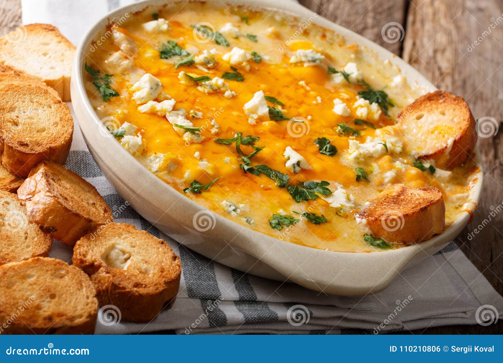 Chicken Buffalo Dip with Blue Cheese and Greens Closeup in a Ba Stock