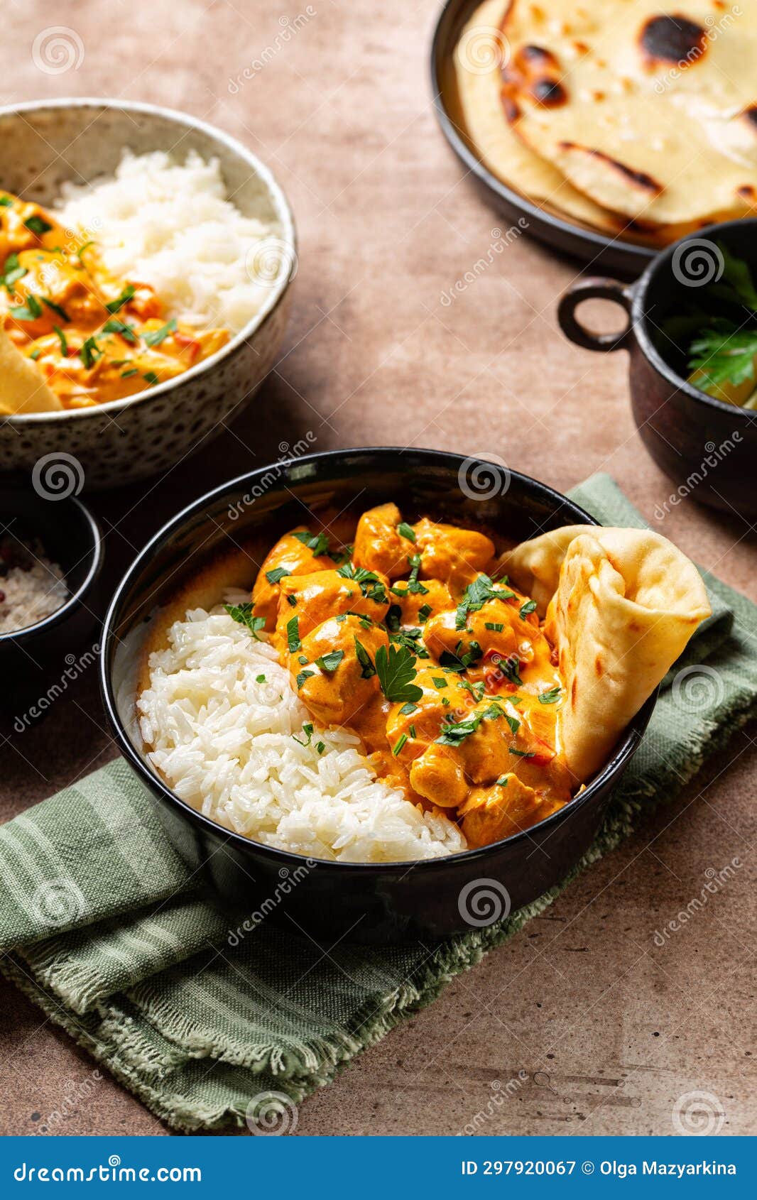 Chicken Curry with Long Rice and Naan Bread in a Dark Bowl. Indian