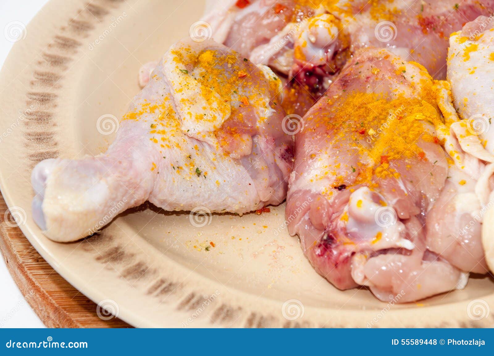 Chicken Drumsticks Seasoned with Curry and Ready for Frying Stock Photo