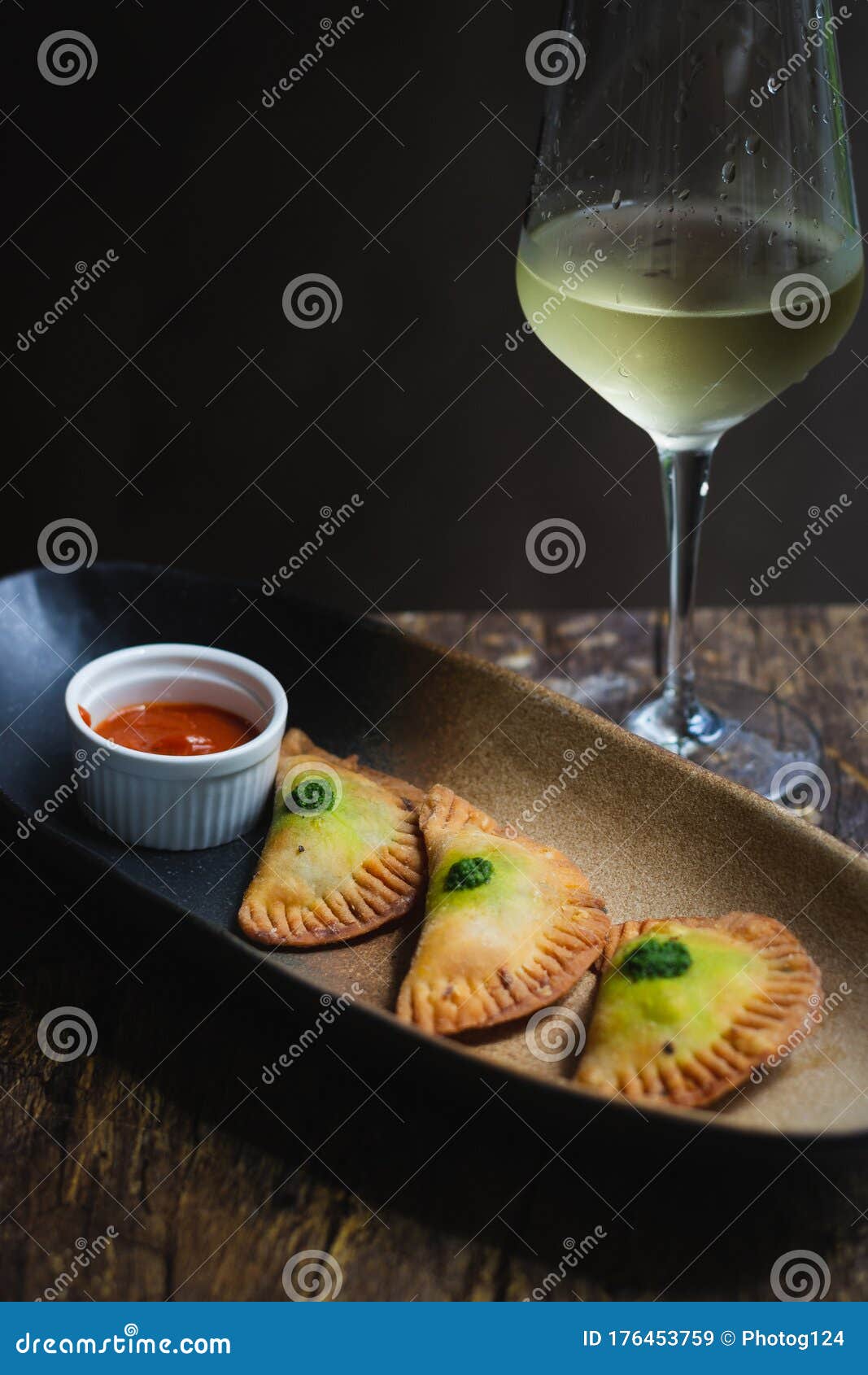 chicken empanadas la abuela style pastry puffs, spinach, green chimichurri sauce