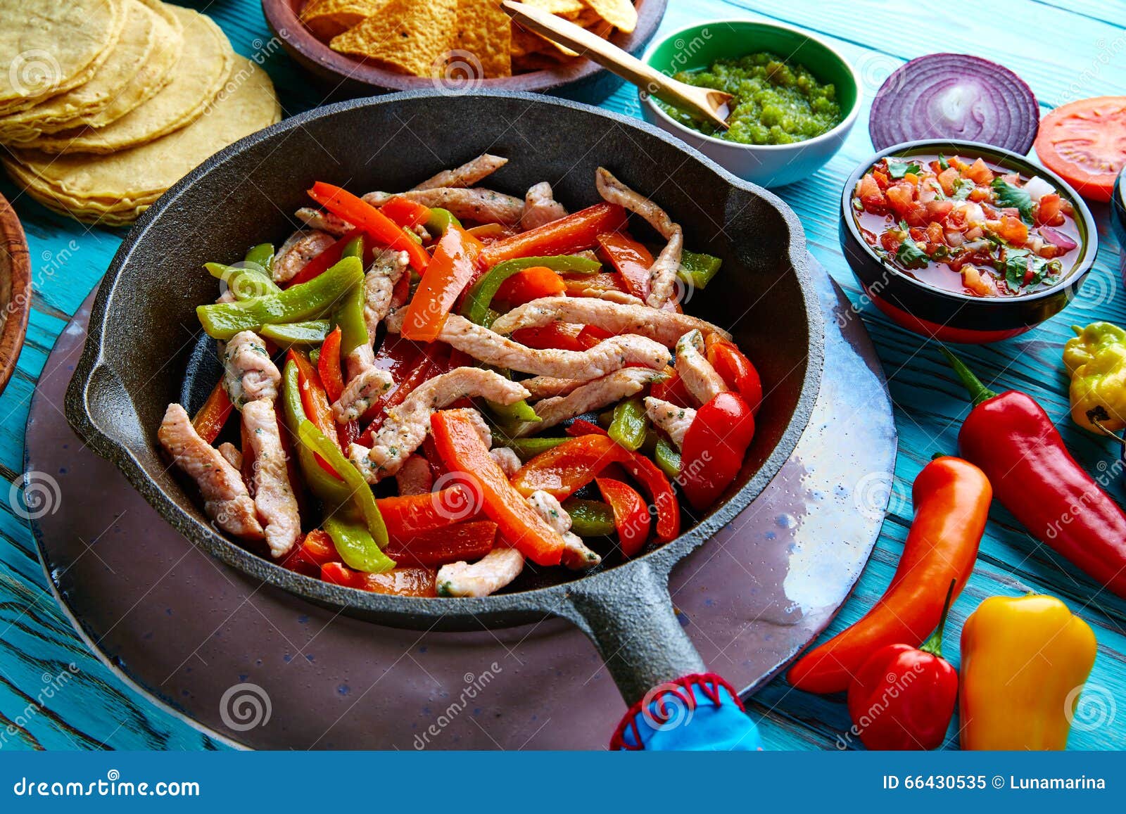 chicken fajitas in a pan chili and sides mexican