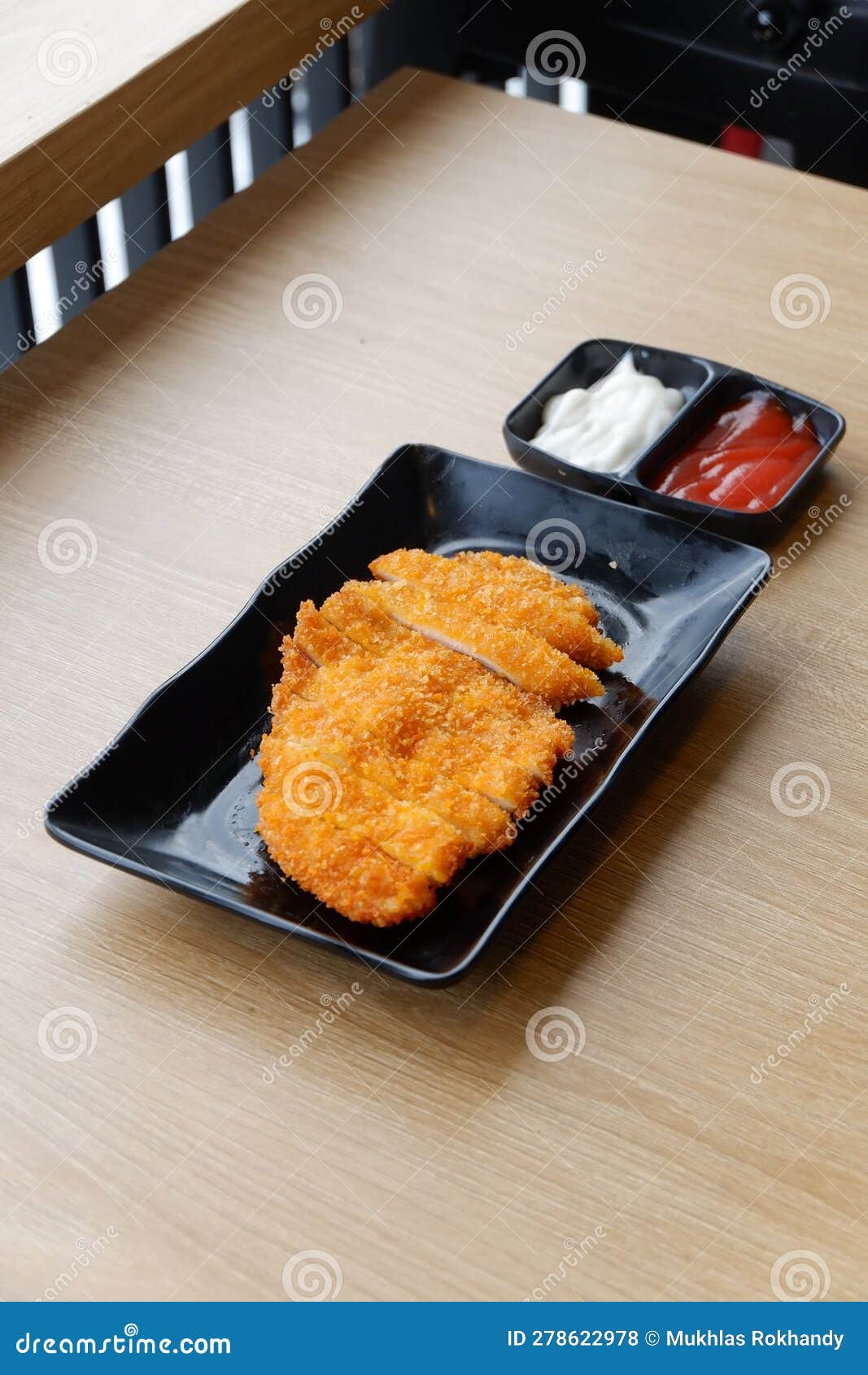 Chicken Katsu with Ketchup and Mayonnaise on the Table Stock Photo