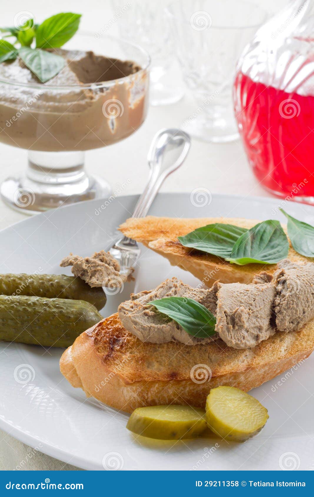 Chicken liver pate. Slice of toasted baguette with liver pate and gherkins