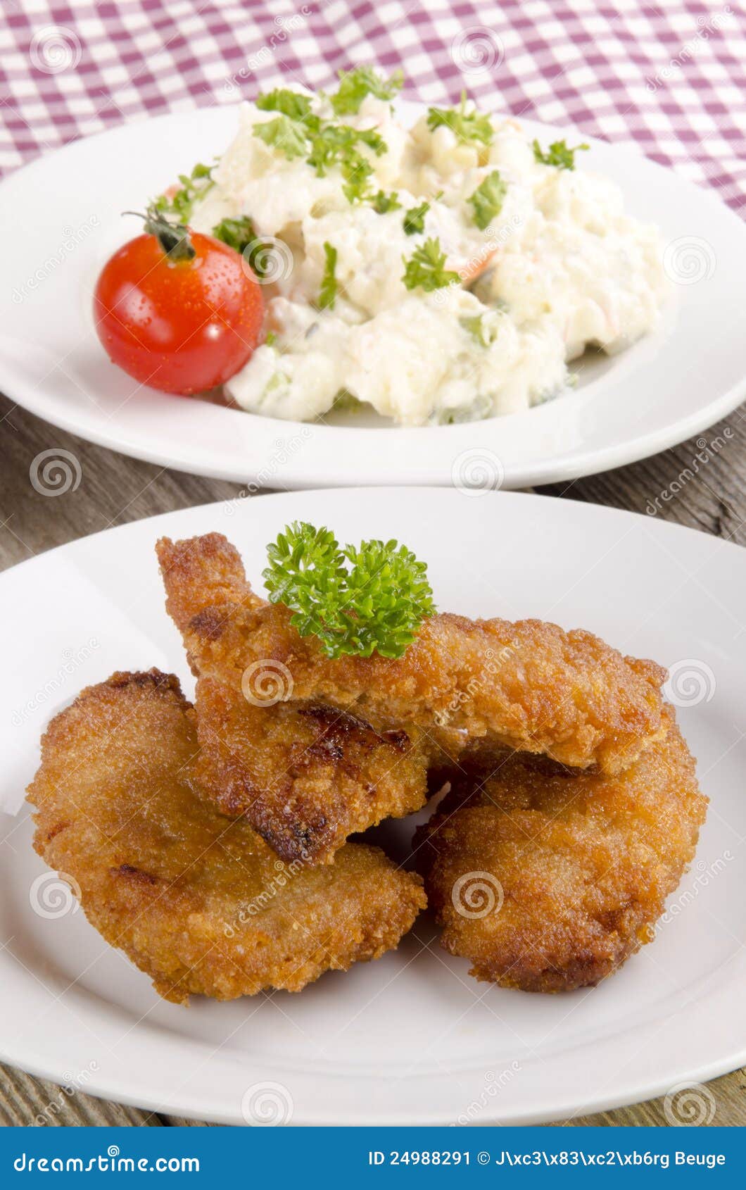 Breaded chicken nuggets with potato salad on a plate