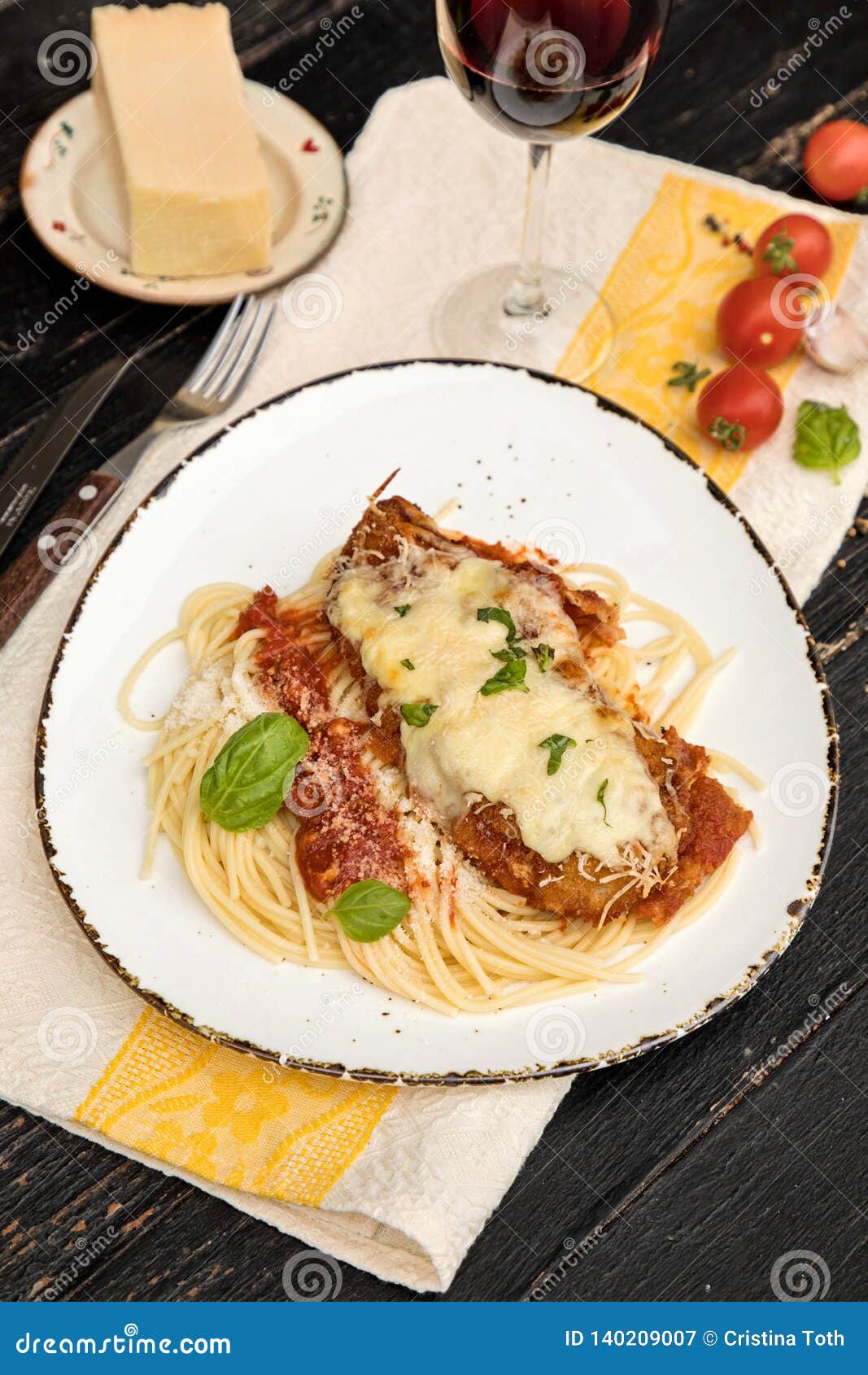 Chicken Parmigiana Served on Top of Spaghetti with Marinara Sauce
