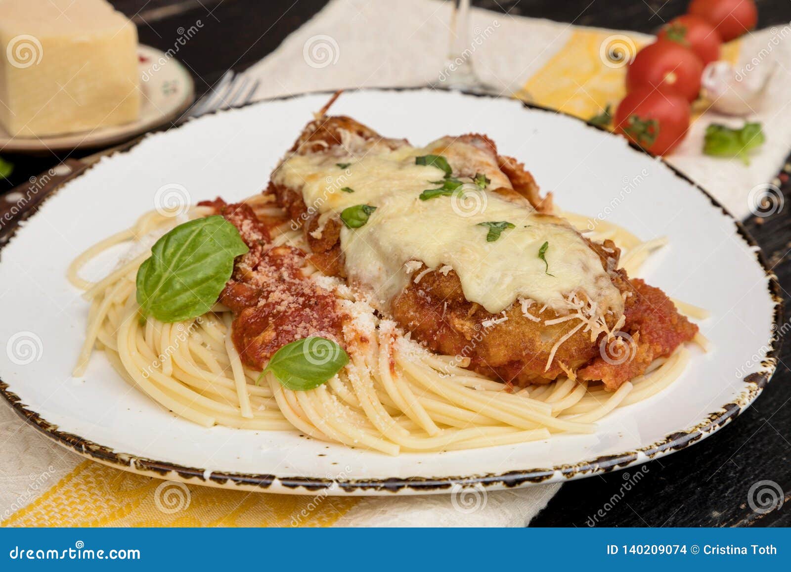 Chicken Parmigiana Served on Top of Spaghetti with Marinara Sauce