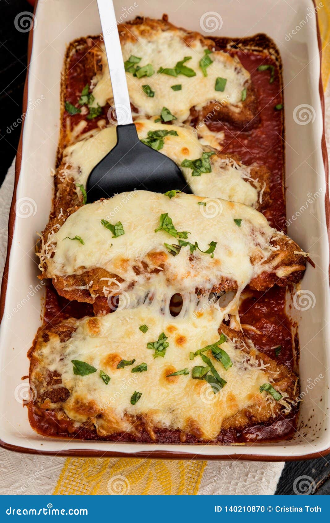 Chicken Parmigiana Served on Top of Spaghetti with Marinara Sauce