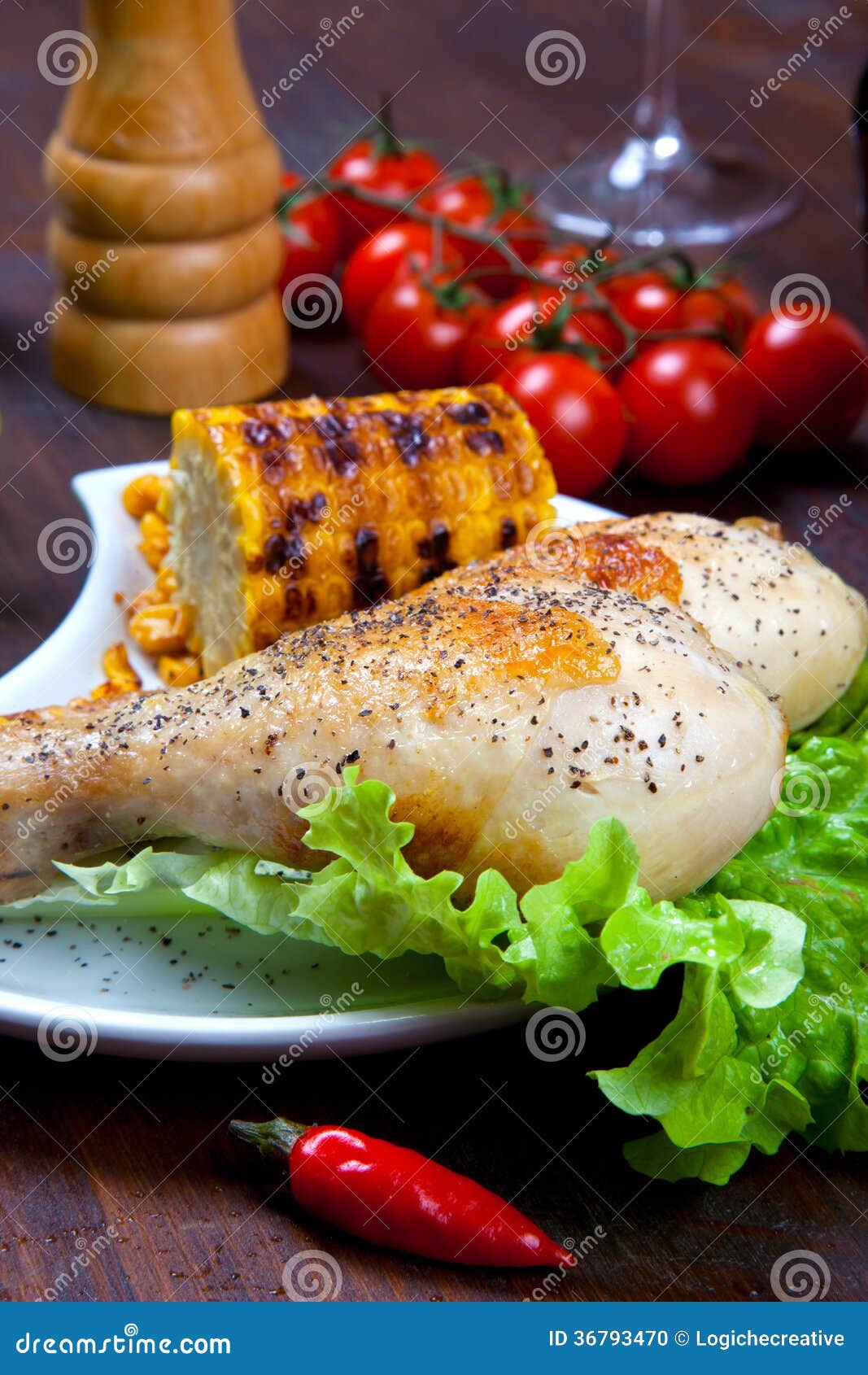 Chicken Thigh with a Boundary of Corn Cob and Salad Stock Photo Image