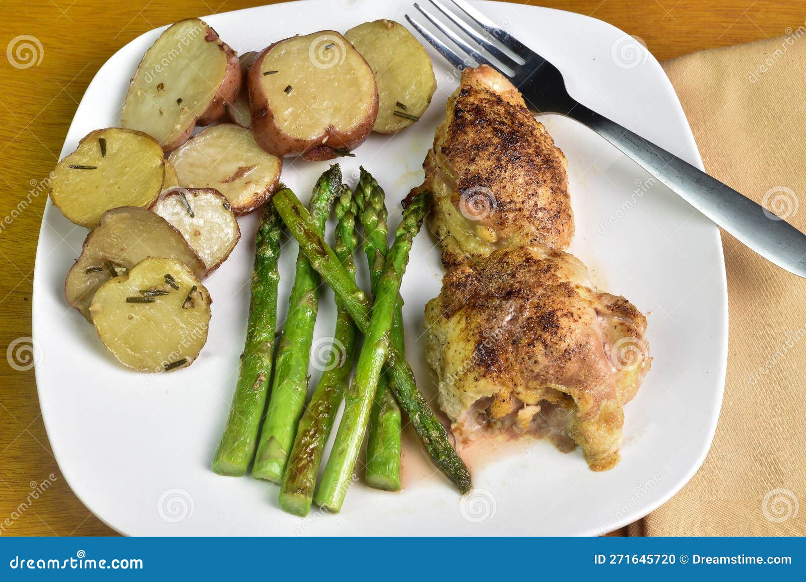 Chicken Thighs Served with Asparagus and Potatoes Stock Photo Image