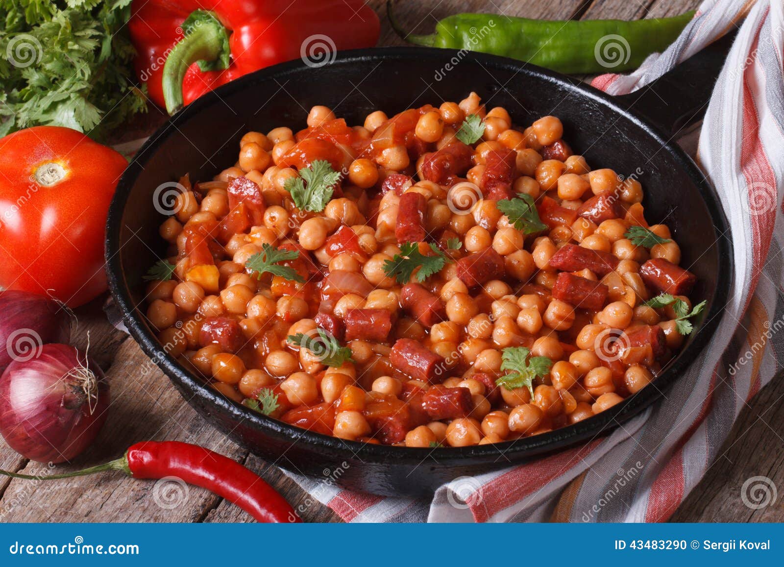 Chickpeas with Chorizo in a Frying Pan and the Ingredients Stock Photo