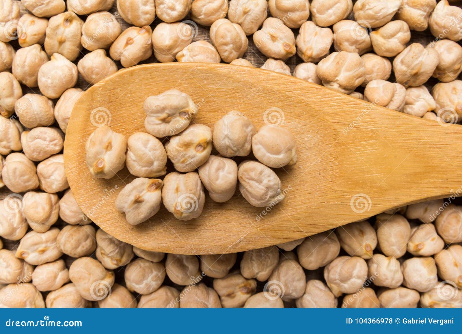 chickpeas. grains in wooden spoon. close up.