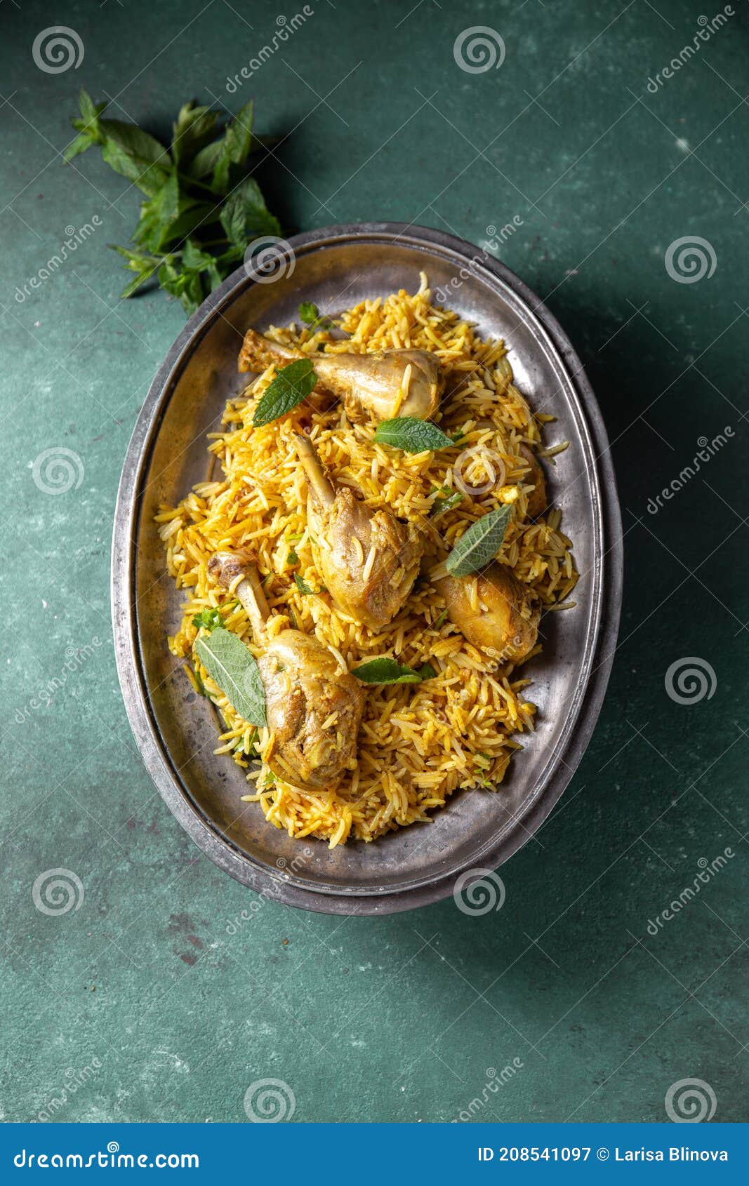 chiken biryani rice with yogur and mint on metal, top view. pakistani and indian dish