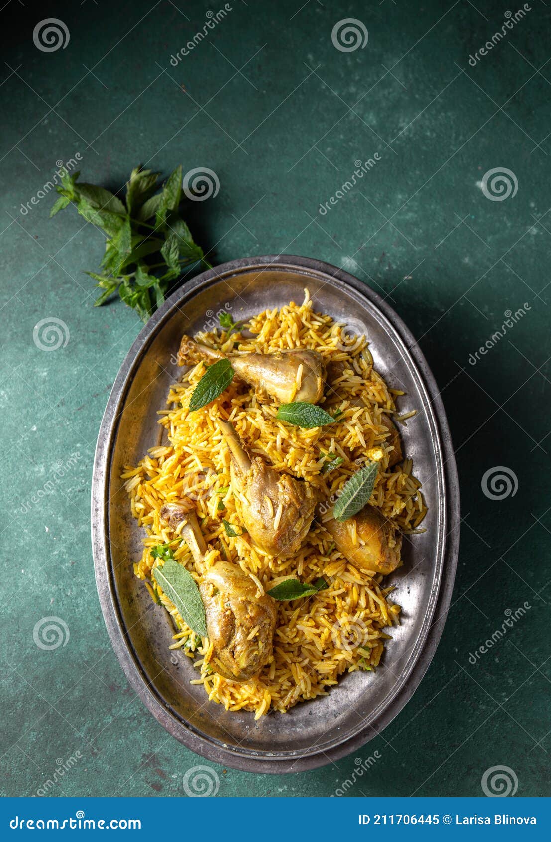 chiken biryani rice with yogur and mint on metal, top view. pakistani and indian dish