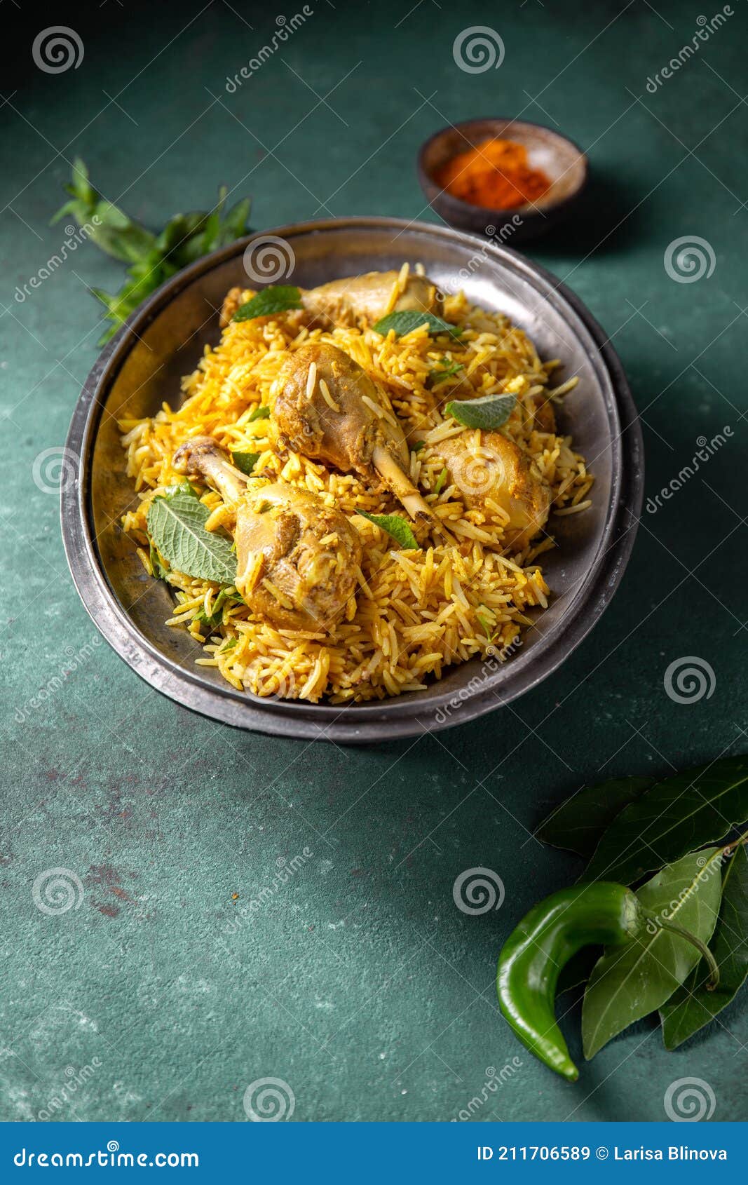 chiken biryani rice with yogur and mint on metal, top view. pakistani and indian dish