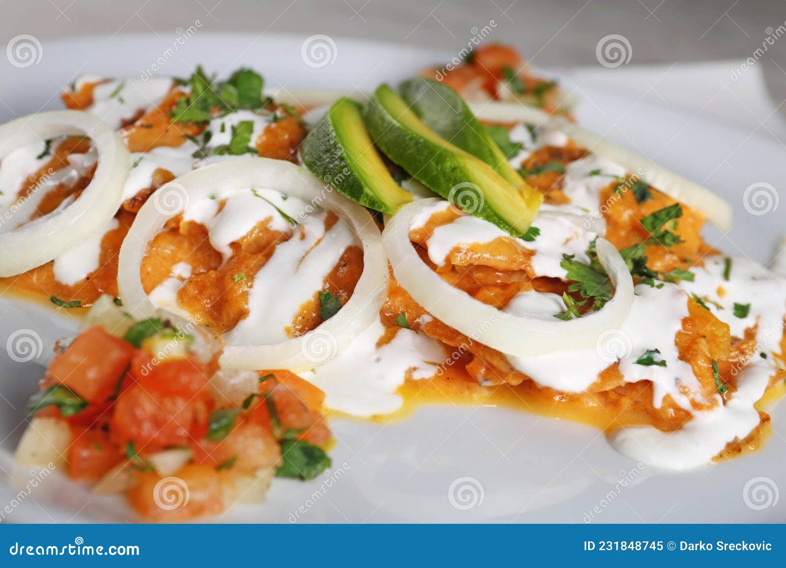 chilaquiles rojos with avocado,mexican breakfast