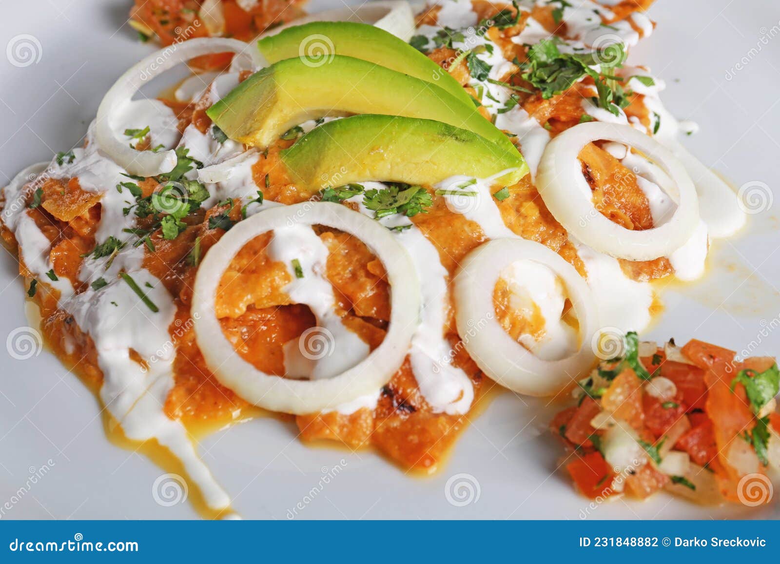 chilaquiles rojos with avocado,mexican breakfast