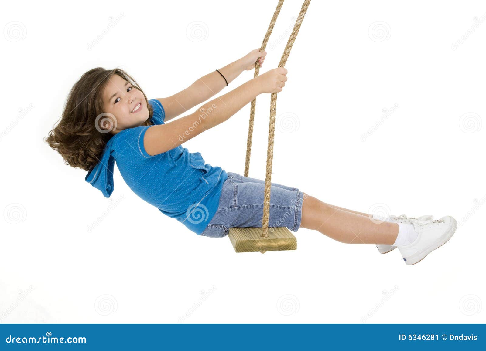 cute caucasian child playing on a wooden swing