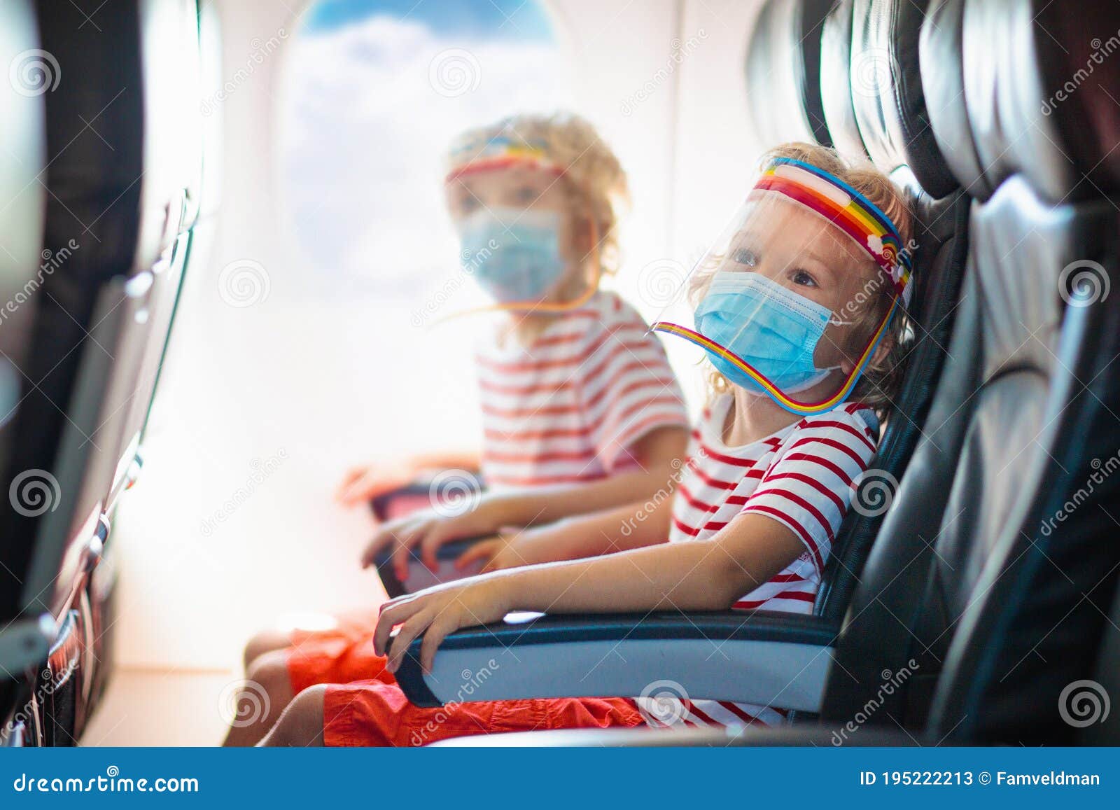 child in airplane in face mask. virus outbreak