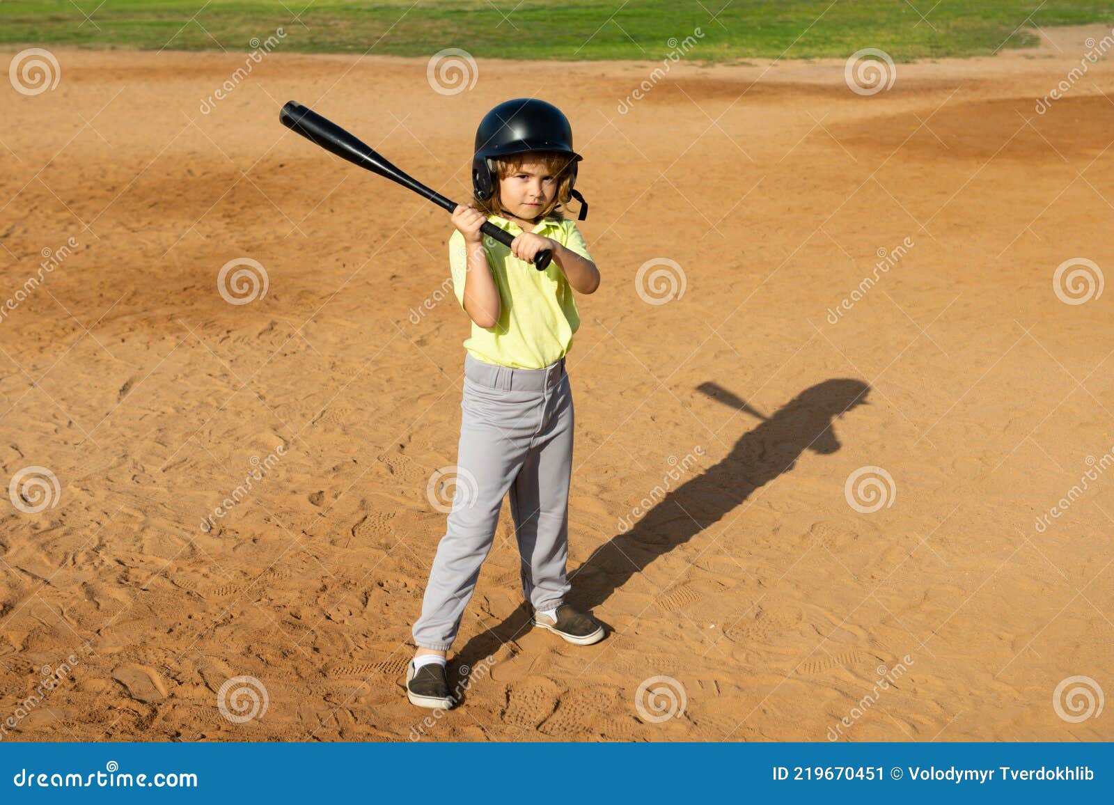 Child Batter about To Hit a Pitch during a Baseball Game. Kid Baseball