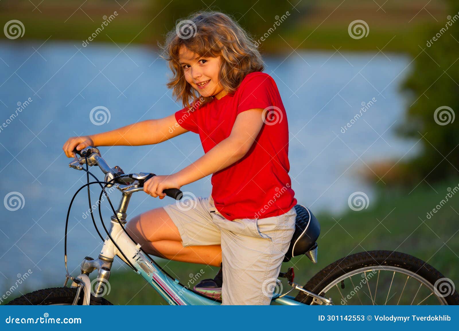 Child on Bicycle. Little Cute Caucasian Boy Riding Bike in City Park ...