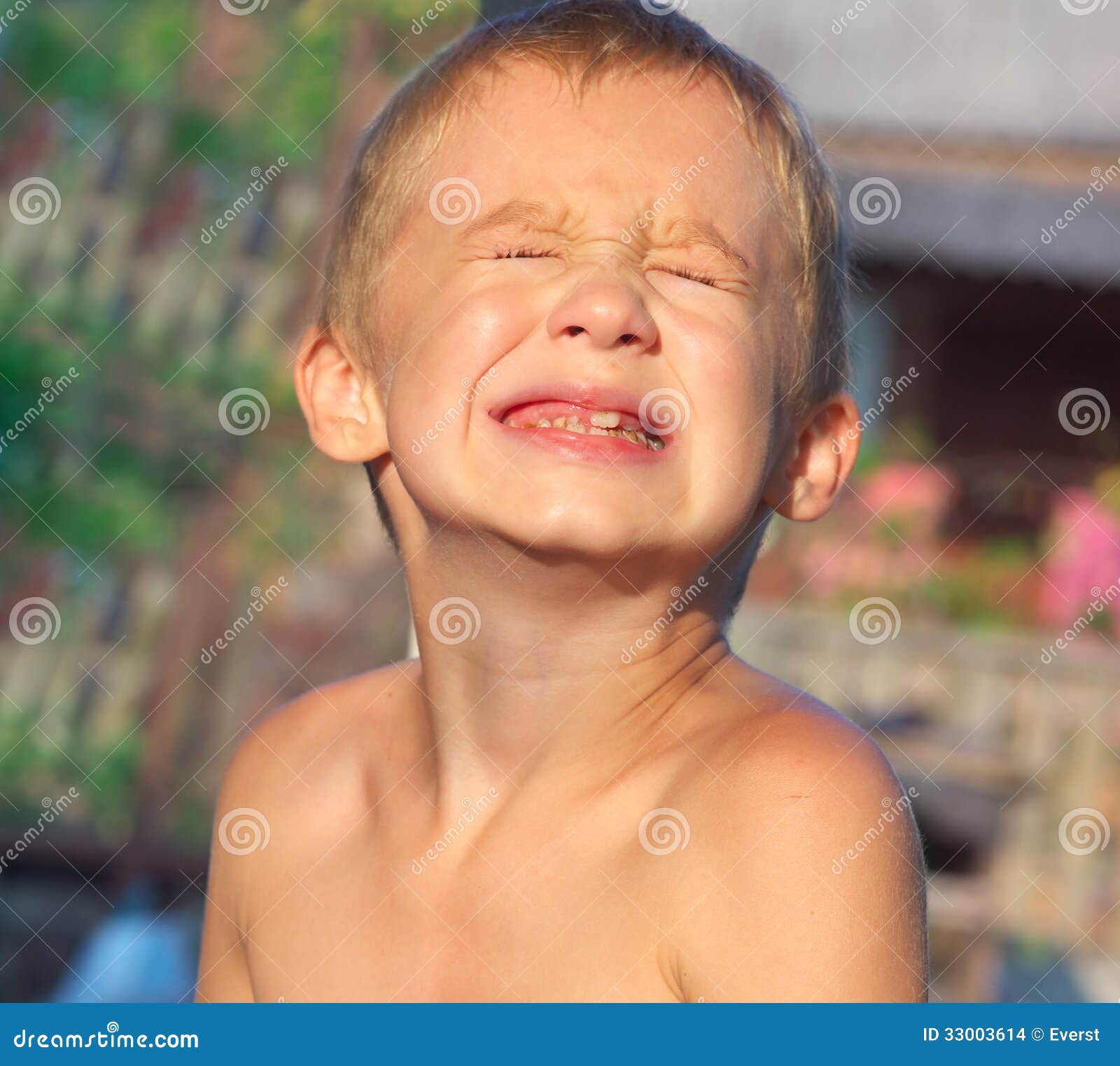 child boy making sore crying faces showing calf's teeth decay