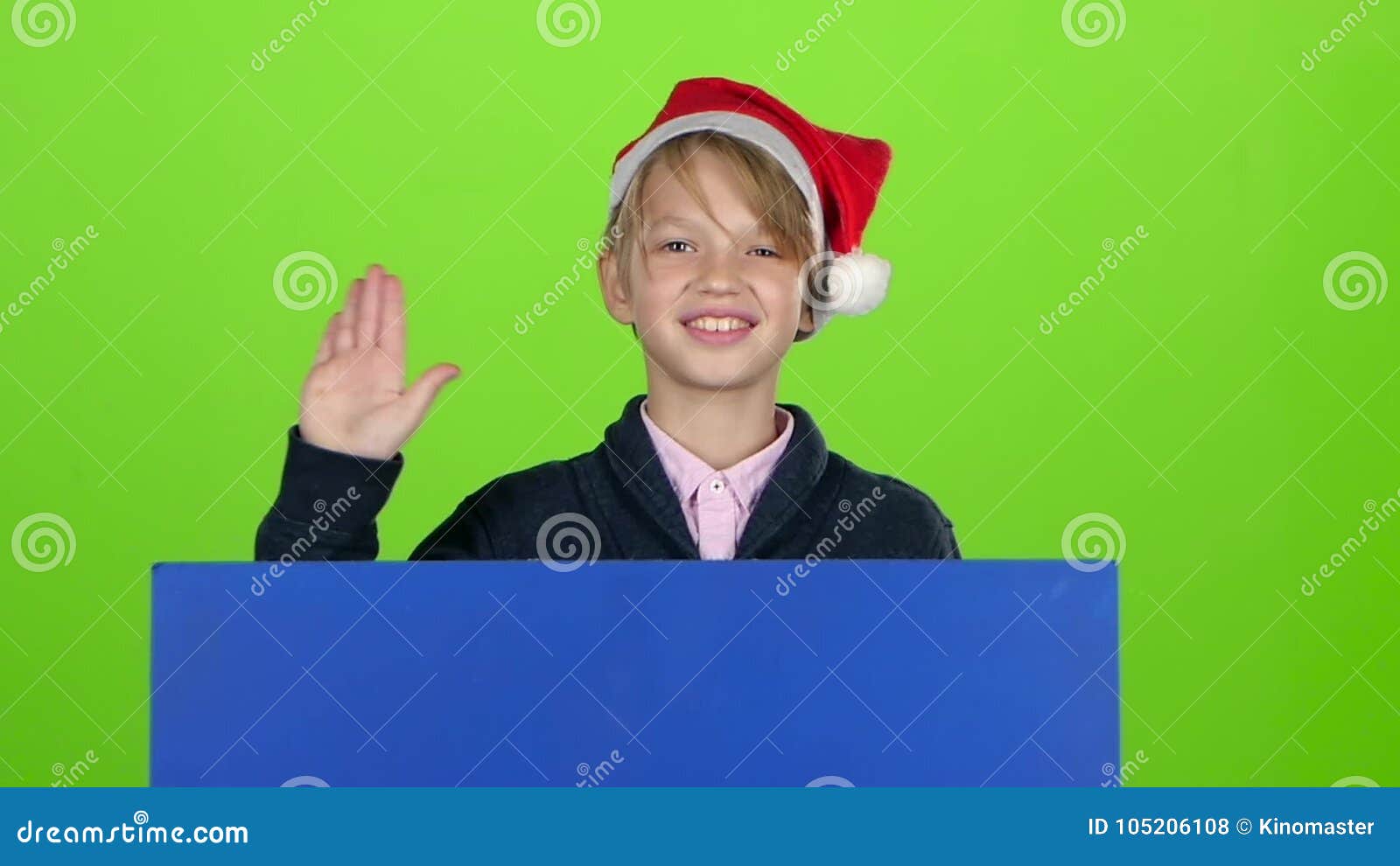 Child Boy Peering Out from Behind Blue Poster Waves a Hand in Front of