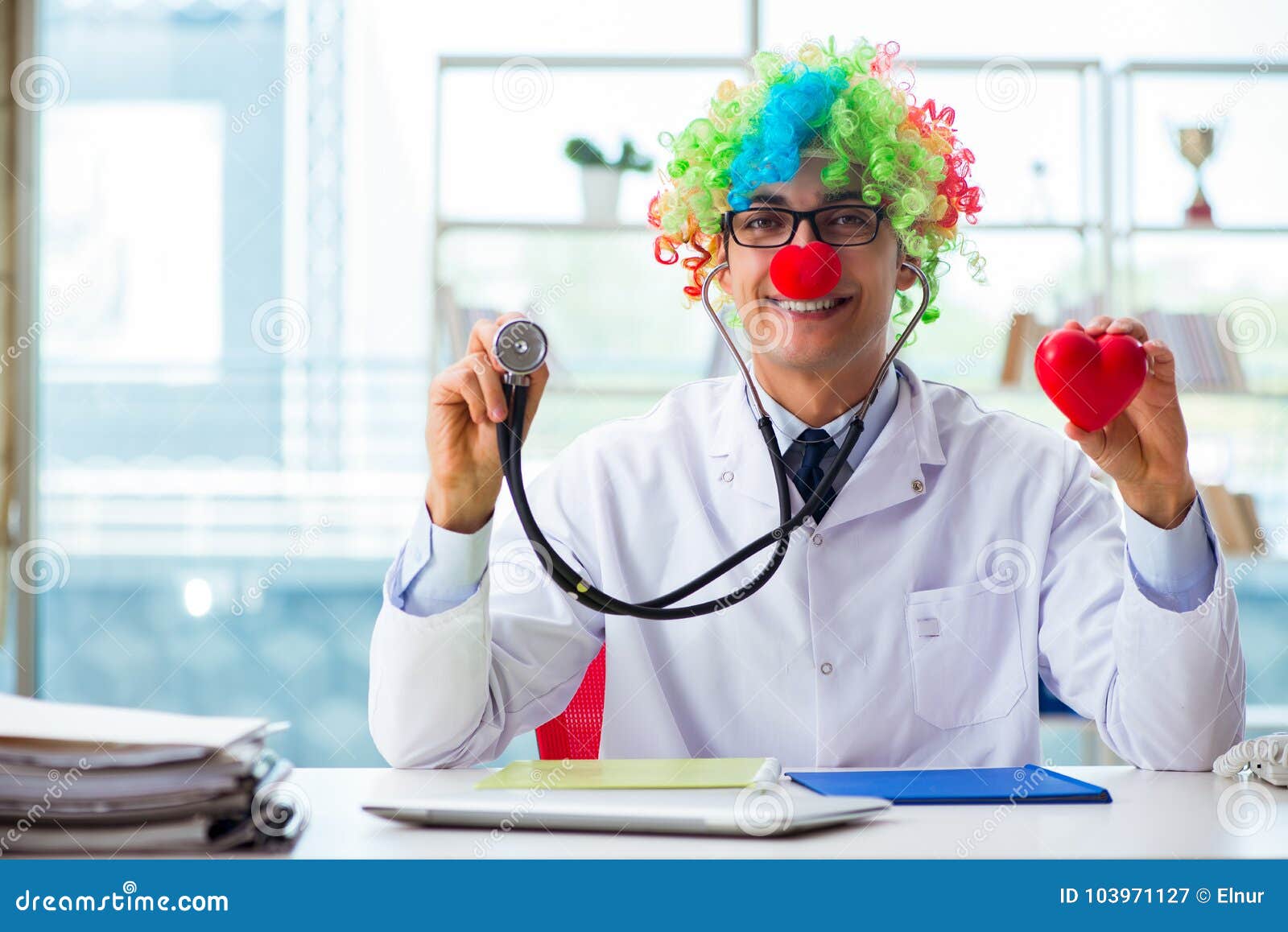 the child cardiologist with stethoscope and red heart