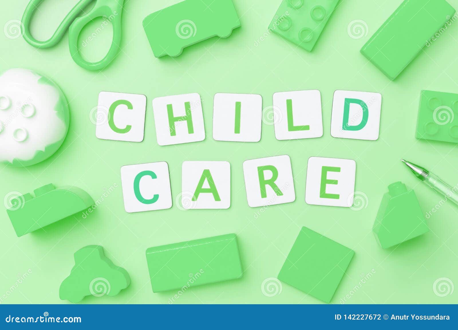 Child Care with Toy Objects for Child Education Concept on Green Stock