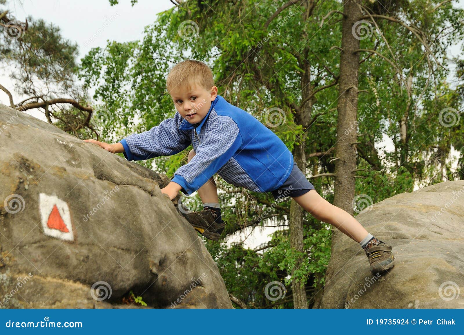 child climbing rock