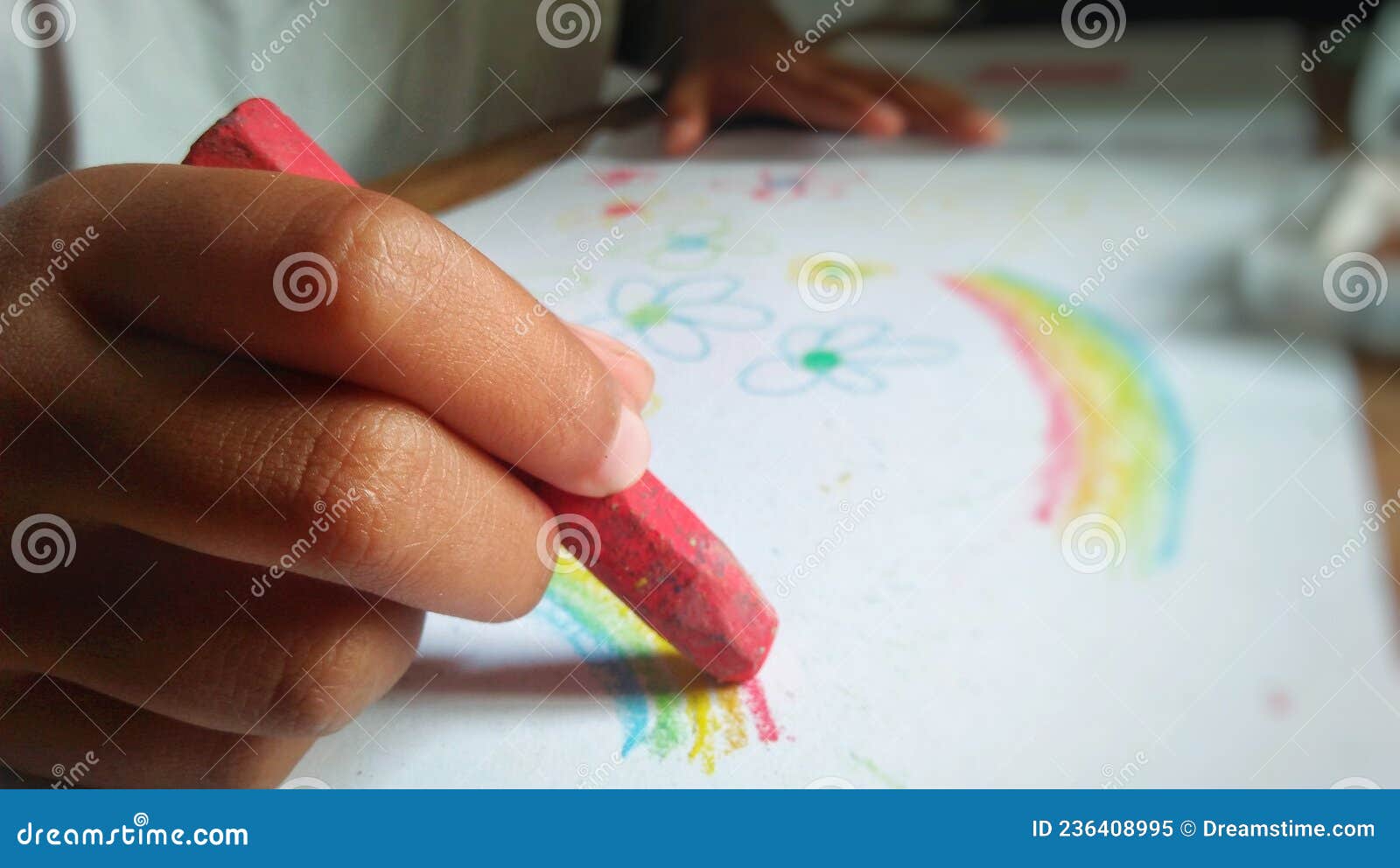 A Child is Coloring with Crayons in a Drawing Book. Education Concept