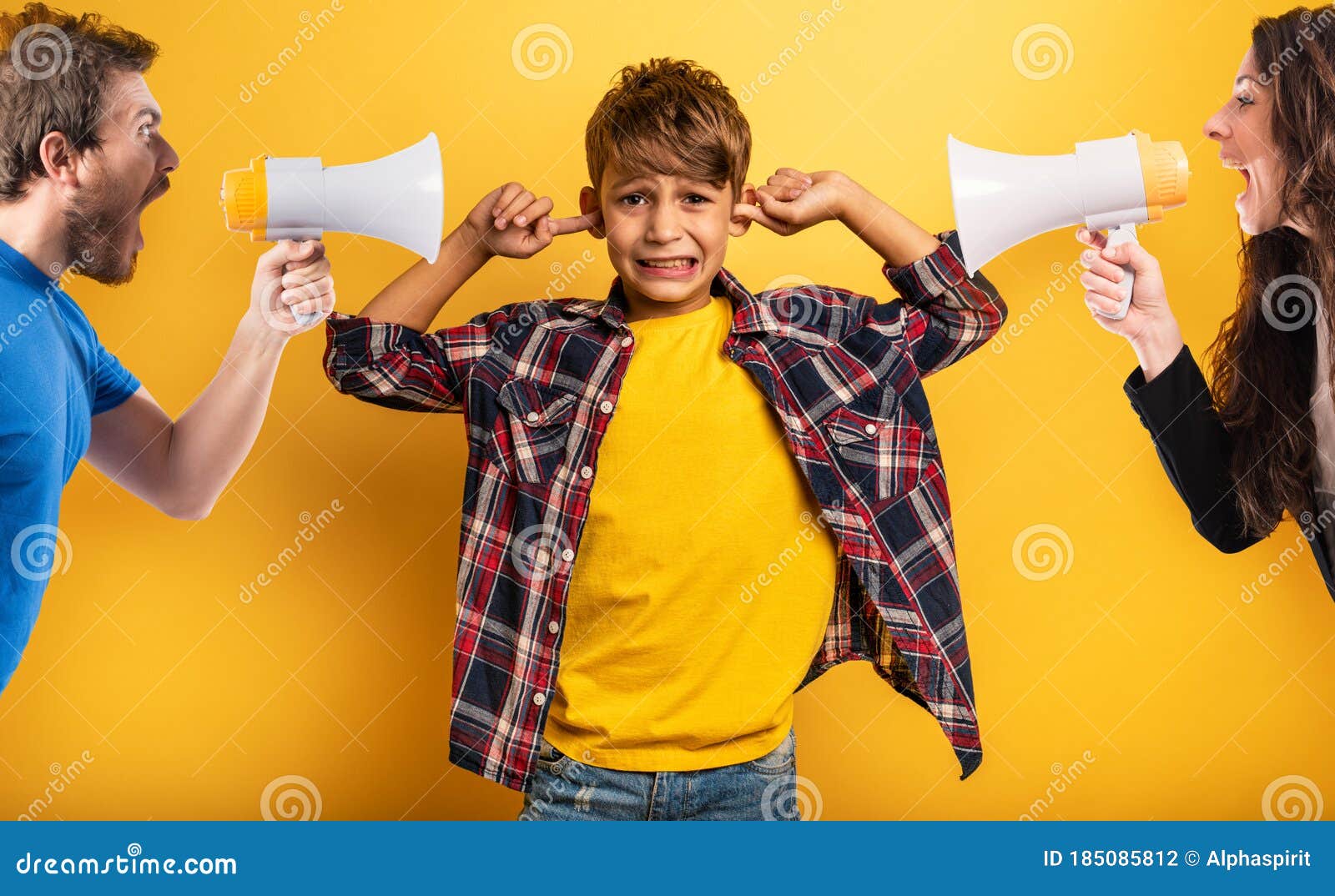 child covers his ears because he does not want to hear the cries and reproaches of his parents. yellow background