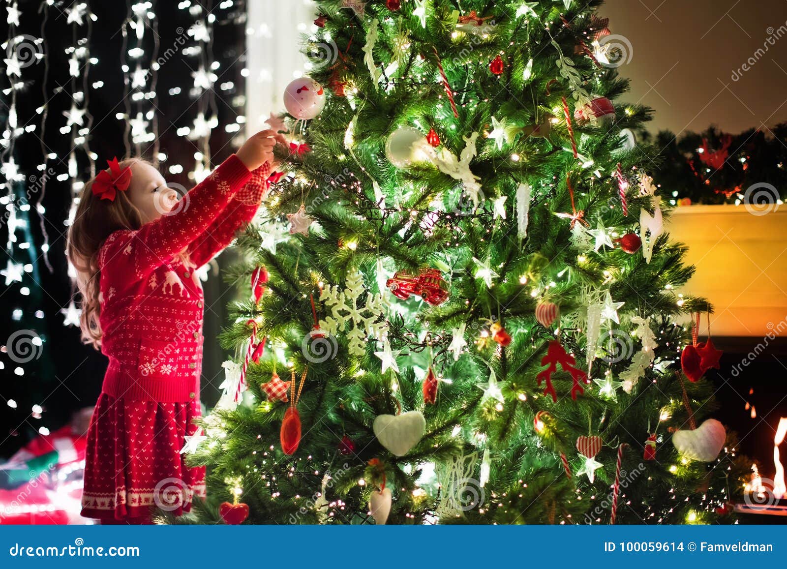 Child Decorating Christmas Tree Xmas For Kids Stock Photo