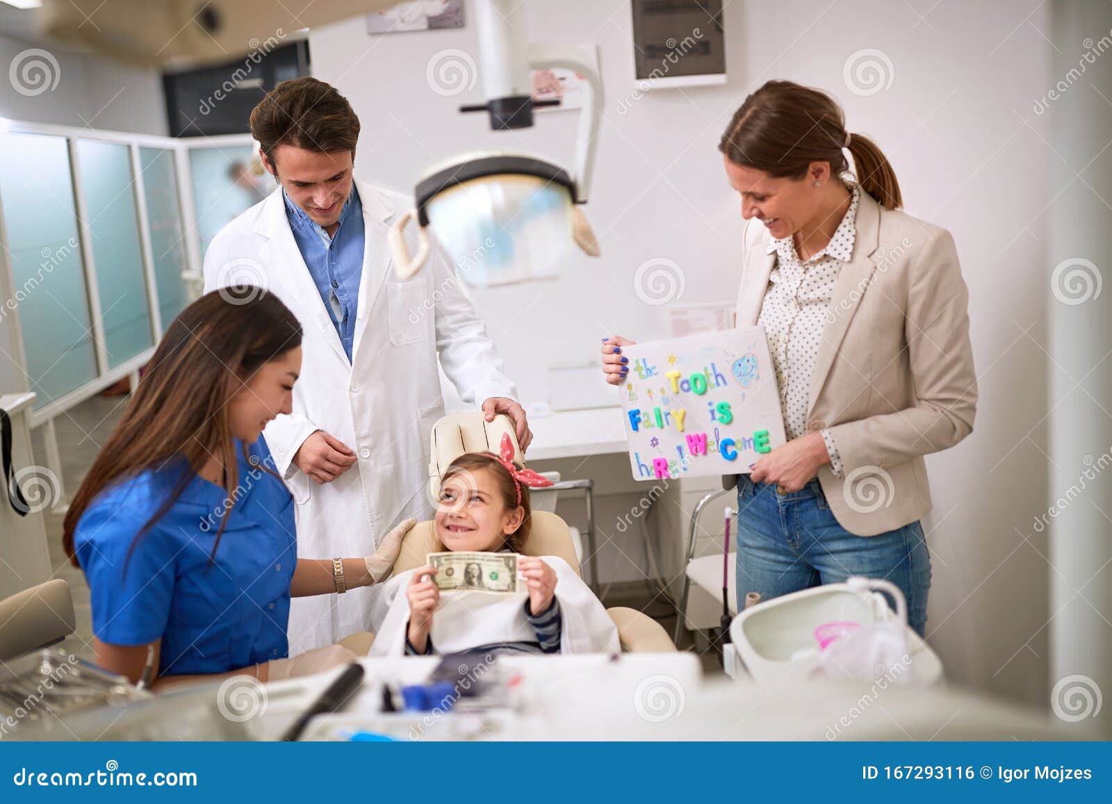 child at dentist hold greenback for luck