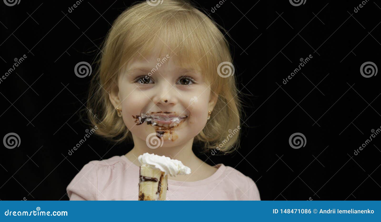 Child With Dirty Face Eats Banana With Melted Chocolate And ...